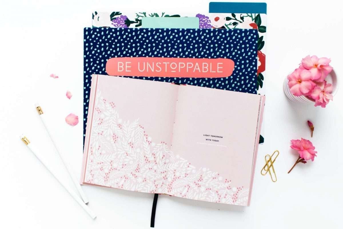 stack of journals on white desk