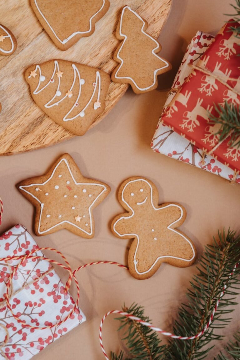 christmas cookies near gifts and pine leaves